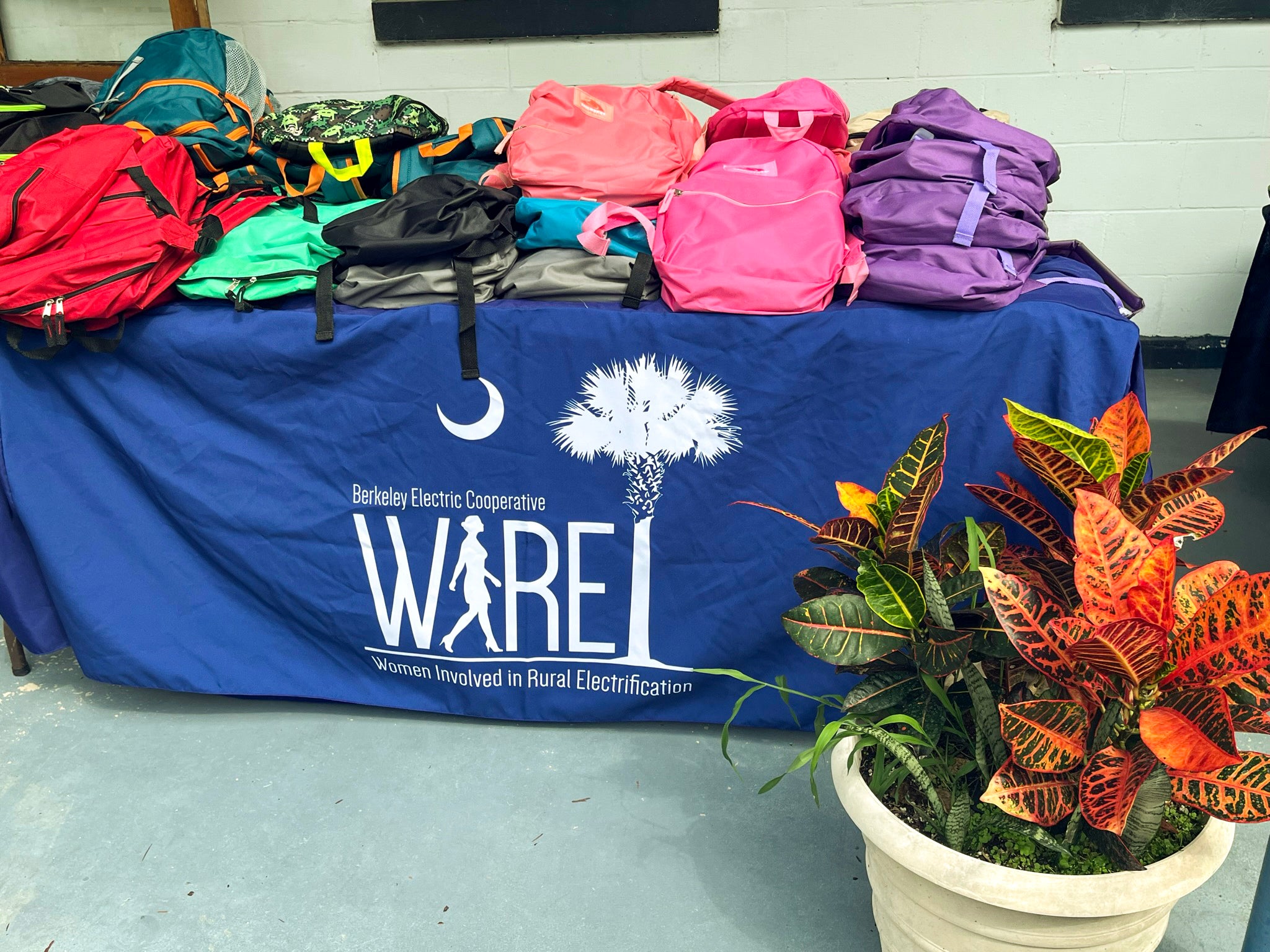 wire table full of backpacks to giveaway