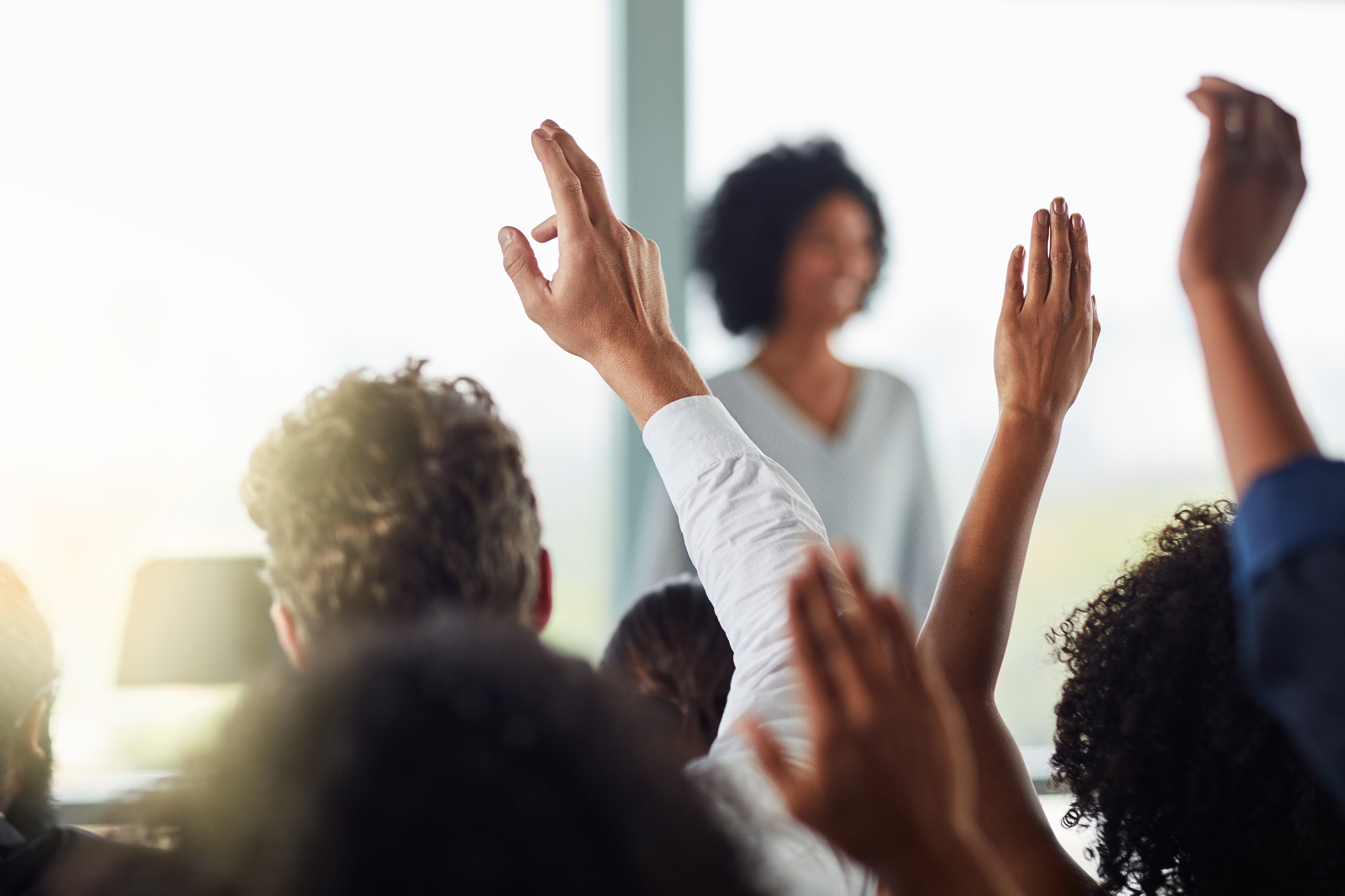 raised hands in a meeting